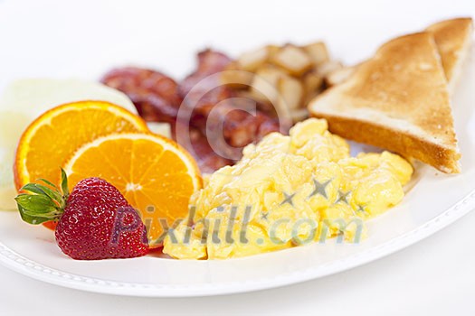 Delicious breakfast of scrambled eggs toast and bacon