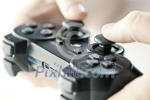 Male hands holding video game controller closeup