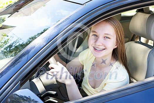 Teenage female driving student learning to drive a car Teenage female driving student learning to drive a car