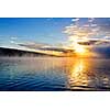 Sun rising over foggy lake in Algonquin Park, Canada