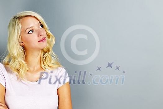 Portrait of young blonde caucasian woman looking to the side and up