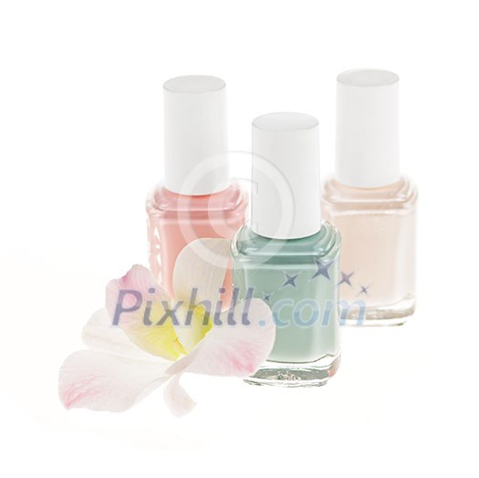 Three nail polish bottles with orchid flower on white background Three nail polish bottles with orchid flower on white background