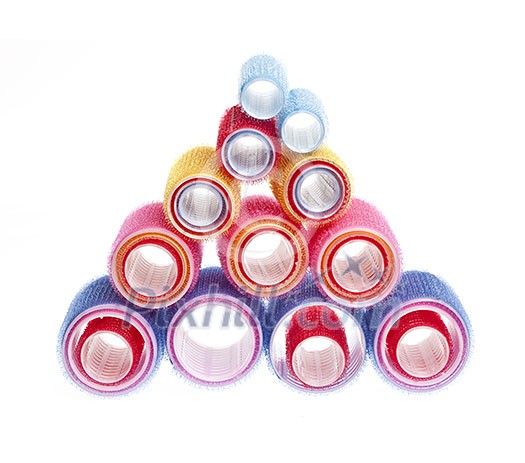 Colorful hair rollers stacked in pyramid isolated on white background