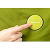 Finger pointing to green round volunteer button