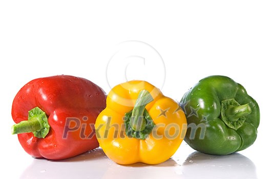red, yellow and green pepper with water drops isolated on white red, yellow and green pepper with water drops isolated on white