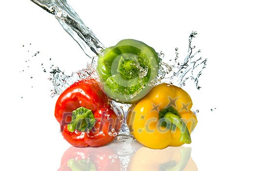 red, yellow, green pepper with water splash isolated on white