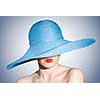 portrait of attractive elegant woman in blue hat