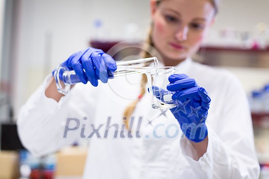 Portrait of a female researcher carrying out research in a chemistry lab (color toned image; shallow DOF) Portrait of a female researcher carrying out research in a chemistry lab (color toned image; shallow DOF)