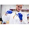 Portrait of a female researcher carrying out research in a chemistry lab (color toned image; shallow DOF)