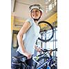 Cycling tourism: young woman traveling by train with her bike