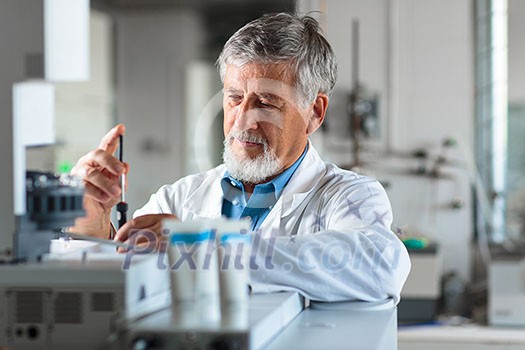 Senior chemistry professor/doctor in a lab (color toned image) Senior chemistry professor/doctor in a lab (color toned image)