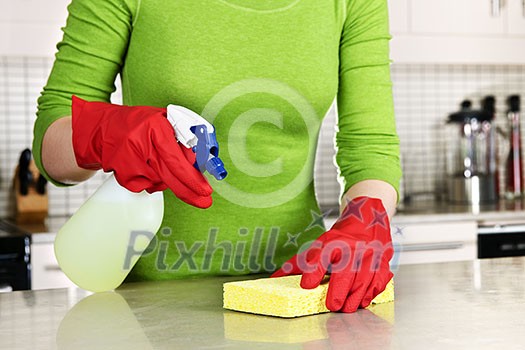 Girl cleaning kitchen with sponge and rubber gloves Girl cleaning kitchen with sponge and rubber gloves