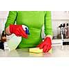 Girl cleaning kitchen  with sponge and rubber gloves