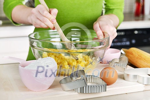 Mixing ingredients for baking cookies in glass bowl