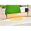 Spreading out cookie dough with wooden rolling pin