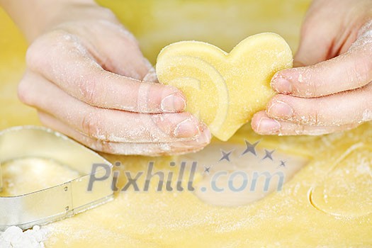 Making heart shaped shortbread cookies with cutters