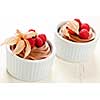 Two servings of chocolate mousse dessert with fruit