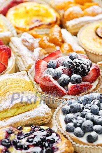 Background of assorted fresh sweet tarts and pastries Background of assorted fresh sweet tarts and pastries