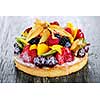 Fresh dessert fruit tart covered in assorted tropical fruits
