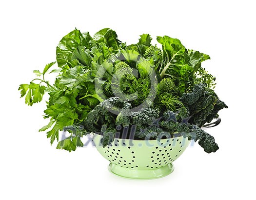 Dark green leafy fresh vegetables in metal colander isolated on white