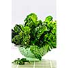 Dark green leafy fresh vegetables in metal colander