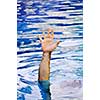 Hand of drowning man needing help and assistance