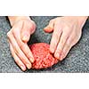 Chef making hamburger patty in kitchen with ground beef