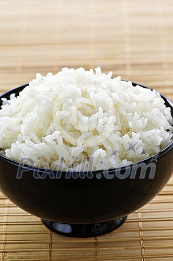 White steamed rice in black round bowl White steamed rice in black round bowl