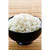 White steamed rice in black round bowl
