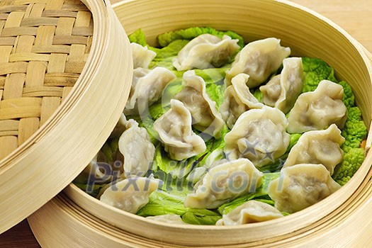 Closeup of bamboo steamer with cooked dumplings Closeup of bamboo steamer with cooked dumplings