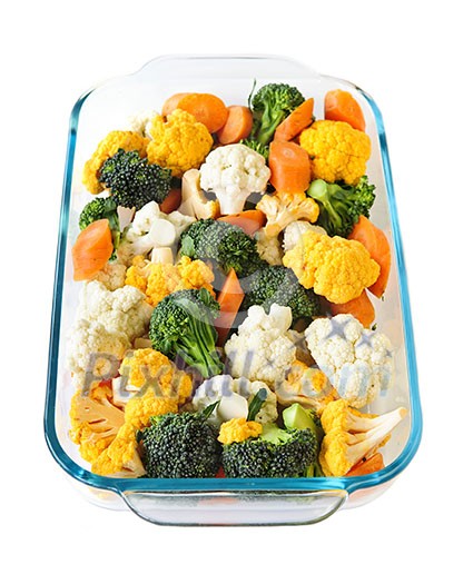 Raw cut vegetables in glass roasting pan Raw cut vegetables in glass roasting pan