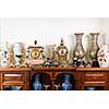 Various antique clocks vases and candlesticks on display