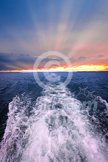 Wake of boat at beautiful sunset on horizon. Georgian Bay, Canada.