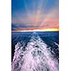 Wake of boat at beautiful sunset on horizon. Georgian Bay, Canada.