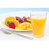 Healthy breakfast of scrambled eggs bacon fruit and orange juice