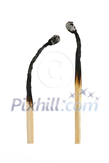 Two burned out wooden matches isolated on white background Two burned out wooden matches isolated on white background