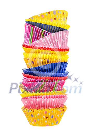 Stacked colorful muffin cups isolated on white background Stacked colorful muffin cups isolated on white background