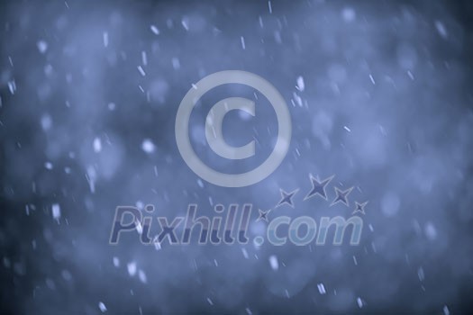 Background of snow flurry falling at night with motion blur