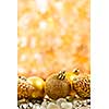 Golden Christmas background with ornaments and pine cones