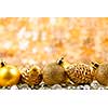 Golden Christmas background with ornaments and pine cones