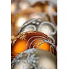 Closeup of golden Christmas balls with festive designs