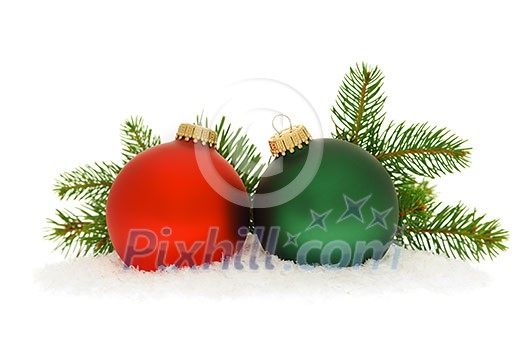 Red and green christmas balls with spruce tree branch isolated on white background