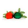 Red and green christmas balls with spruce tree branch isolated on white background