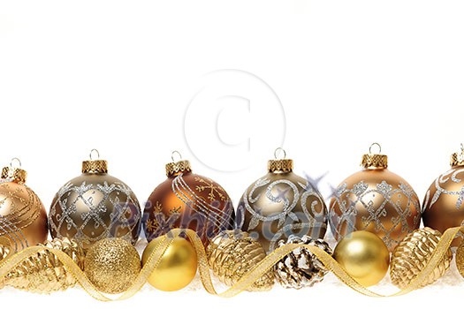 Golden Christmas decorations with gold balls and ornaments on white background