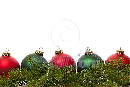 Row of green and red Christmas ornaments with pine tree branches