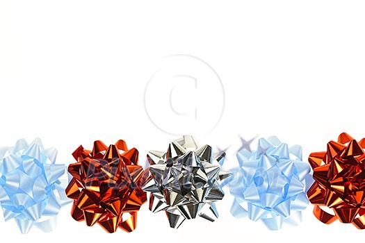 Row of multicolored gift wrapping bows isolated on white background