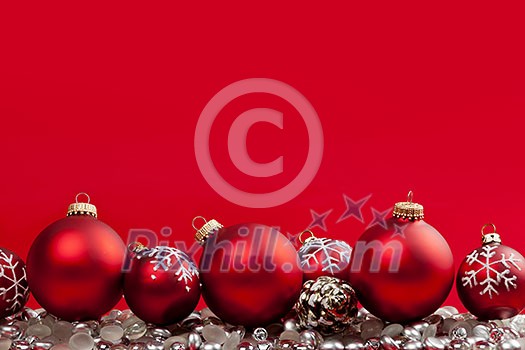 Red and silver Christmas decorations on crimson background Red and silver Christmas decorations on crimson background