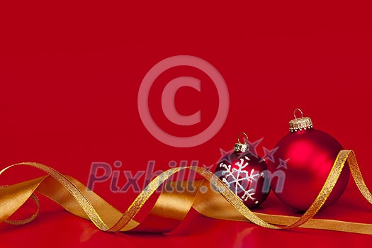 Red Christmas background with ornaments and gold ribbon
