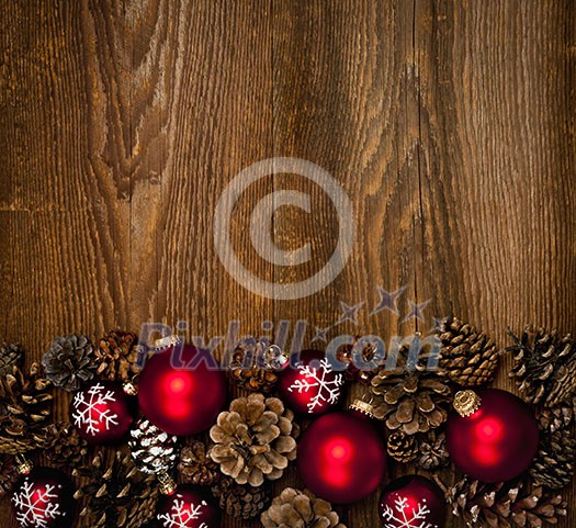 Rustic wood background with Christmas ornaments and pine cones Rustic wood background with Christmas ornaments and pine cones