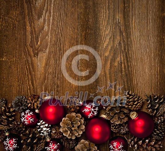 Rustic wood background with Christmas ornaments and pine cones